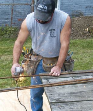 As soon as the holes pass inspection, I cut five 18-inch lengths of 1/2-inch rebar for each hole.