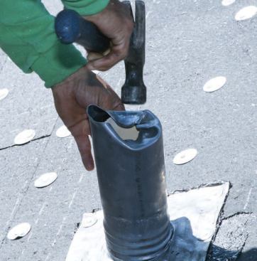 The lead flashing is nailed off and bent around the top of the pipe.