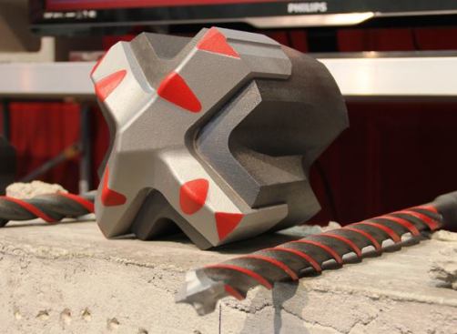 No, Milwaukee doesn’t make rotary hammer bits quite so large as this. The item on the left is a plastic mockup of the tip of a 4-flute bit that is said to last particularly long when drilling concrete that contains rebar.