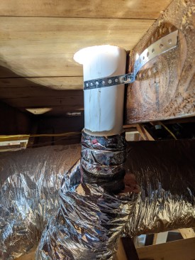 The insulation jacket is cut longer than the inner sleeve to allow the insulation to be pulled over the short PVC pipe, insulating it up to the roofline. 