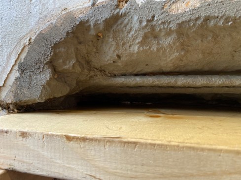 A closeup shows the fully prepped repair surface and form, ready for packing in the repair mortar.
