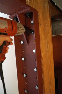 The crew alternated holes when driving the lags to draw the bracket in uniformly.