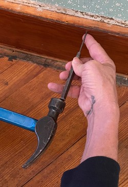 When you need to preserve a board, you can't mar the face with a catspaw. Instead of pulling nails, use an 1/8-inch pin punch to drive finish nails through the back of the board. Â Â When the punch has been driven deep, it's sometimes hard to pull back out, but you can pry it out with the claw of a hammer.