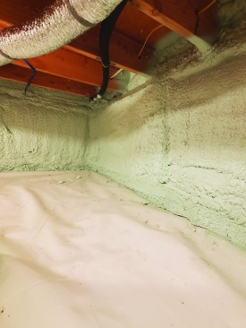 In the crawlspace, one layer of 2-inch Comfortboard 80 was topped with CleanSpace, a 20-mil puncture-proof vapor barrier. Closed-cell spray foam (R-16) locks the vapor barrier to the walls, connecting the wall insulation to the floor insulation.