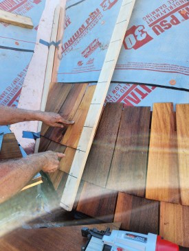 After installing ice-barrier membrane, self-adhering underlayment, and copper flashing, the crew began installing shingles on the turrets using a story pole that hooked over the top of the turret so it could be rotated around the front to keep the shingle courses even.