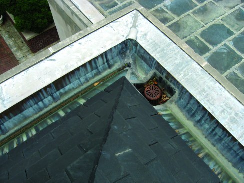 Drains are often positioned poorly, as in the corner of this gutter, where there is no room for a clamp ring and no room to solder. 