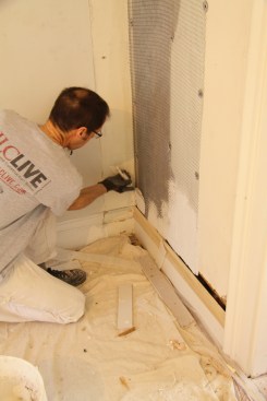 I mixed the base-coat plaster to a thick consistency, and I started
applying the plaster along the bottom of the wall.