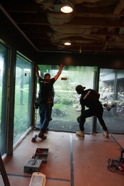 After protecting the floor below the A-frame wing, subcontractors from the window company removed the lower windows.