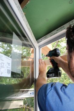 Schuco windows are held in place by self-tapping lag screws supplied with the units and driven through holes predrilled in the frame.