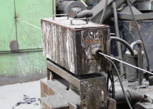 After exiting the descaler wire passes through a box where loose particles are blown off with compressed air and captured by a dust collection system.