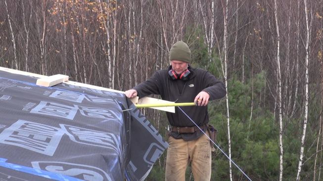 Measuring the distance from the rafter tail to the face of the I-joist wall buildout framing.