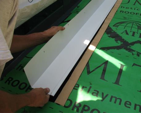 … and bonds it to the outboard edge of the roof leg of the continuous flashing