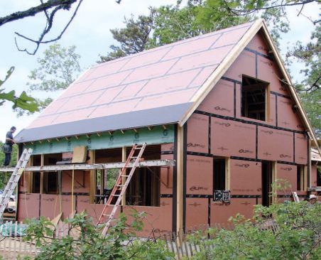 Note the layer of housewrap under the eaves, installed in advance as the rafter tails were being added. Later, the entire shell was covered with housewrap.