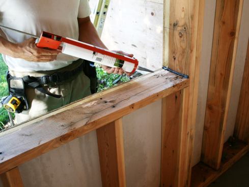Start off by running a thick bead of Liquid Flash at the corner of the rough opening.