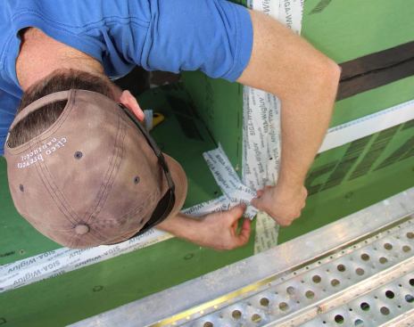 Sealing the corner joint of the opening with a strip of Wigluv tape.