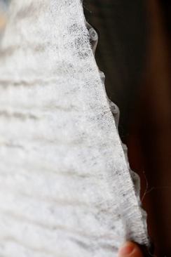 It’s hard to get a good close up on the fabric, but it look alot like a silt fence material. Obviously porous and lightweight but tough.
