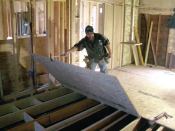 Finally, I insulated the ends of each joist bay against the outside wall with fiberglass batts. To complete the floor system, I glued and screwed 3/4-inch OSB subfloor to the joists, staggering the end seams as I went along (18). In the end, the extra time I spent paid off. The floor was completely flat, level, and solid as a rock—a perfect foundation for the new kitchen cabinets.