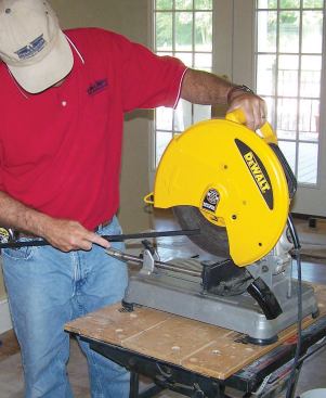 There are often burrs and rough edges on the baluster base after the cut, so I clean them up using the side of the spinning cutoff blade.