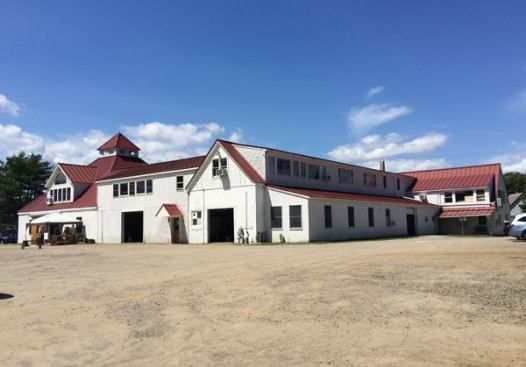 This is a view from the back of the main building in Warren, Maine. It contains a production facilitiy, offices, a demo room, and a small retail store. Hand saws, chisels, planes, and other metal tools are fabricated and assembled at this and a smaller building nearby. Work benches and wood parts (knobs, handles, and the like) are made at a facility in a nearby town.