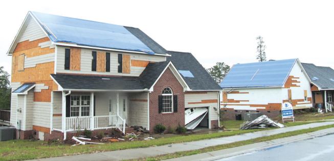 These two homes lost much of their fiber-cement siding, but there were no breaches in the OSB sheathing.