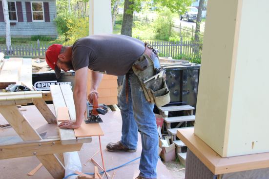 Fenton cuts his scribed line for the taper on his next shingle.