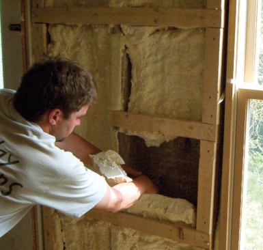 Defective B-rich foam, like that shown here, is characteristically soft and sticky and has a distinctive chemical odor. The material has not bonded to the sheathing beneath and can easily be pulled from the framing cavities by hand.
