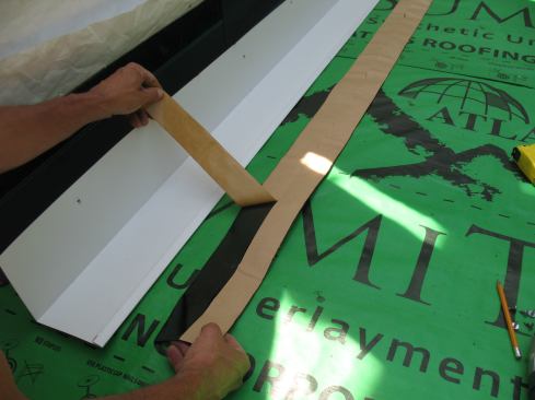 Then Mike removes the backing from half of the first strip ...