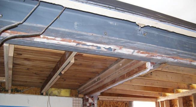 The existing second-floor joists, which had been cut back to allow the steel to be inserted, were sistered with new full-span LVL joists.