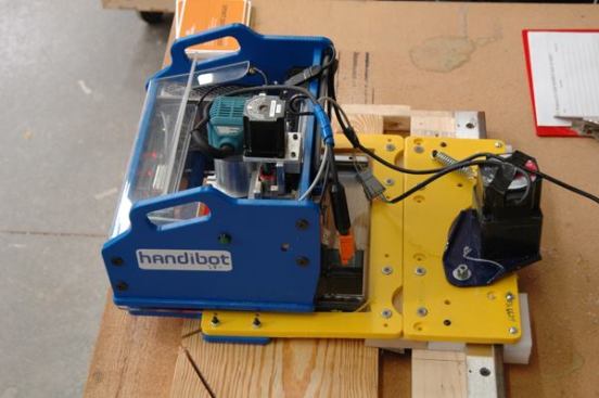 ShopBot’s Handibot—the first portable CNC “robot”. Note the Makita rouer motor that is used to do the cutting.