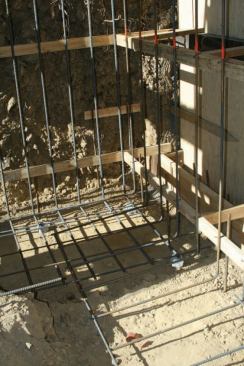 The retaining wall foundation required a serious amount of rebar, including L-shaped pieces coming up from a wide footing.