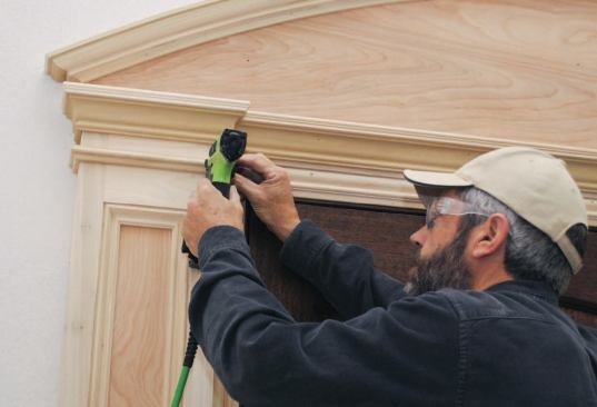 I also profiled short sections of matching straight material to use for the mitered returns. When installing the three-part molding, I started with the middle section, then fit the bottom and top sections and added the returns. Finally, I added the transitional molding, a combination of 11/16-inch-by-2 1/8-inch and 3/8-inch-by-1/2-inch panel mold profiles, to hide the joint between the casing trim and the plywood.