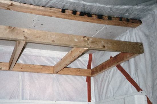 When planning for a light fixture above a tub, it sometimes makes sense to lower the ceiling to keep the electrical box from penetrating the poly ceiling barrier.