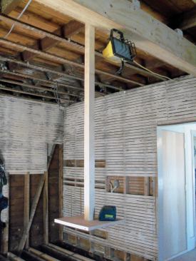 It became obvious that I would need a place out of the way to position my laser at a consistent height while I installed the joists. I ended up building a small platform that I suspended from the ceiling near the middle of the room.