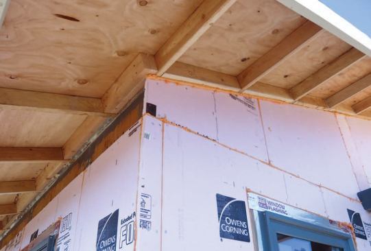 It is sealed to the exterior wall insulation board with spray foam.