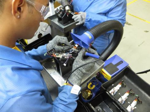 This worker is soldering the wires from a switch assembly to the contacts on a brushless motor. The switches came out of a box labeled Thailand and the motors out of a box labeled China. Other parts were produced in the U.S. by SB&D: plastic housings in Cheraw, SC, gear housings in Hampstead, MD, and machined parts in New Britain, CT. The rest of the parts come from other places. And of course, sourcing varies by product and can change over time; DeWalt plans to begin building brushless motors in Charlotte later this year.