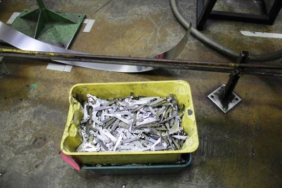 These pieces were punched out by the dies in the previous photo. They are called scales, which is the name for the decorative pieces on the outside of a folding knife or multi-tool.