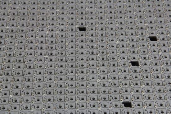 These replaceable jaws for wire cutters are made from material that’s too hard and thick to run though a punch press so they were cut with the computer-controlled laser shown in the previous photo. A few of the pieces popped out of the sheet on their own; the rest will be removed by a production worker.