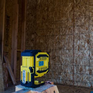 A height-adjustable foot releases and locks at the flip of a lever, allowing you to fine-tune the elevation of the horizontal laser line. Extending it gives a clear view of the downward plumb point. Uhler and his crew found it a little top-heavy in this position, so it knocked over easily.
