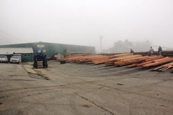 The main mill building is where logs are turned into boards. There is also a planing mill, offices, and buildings that house the machinery for debarking logs and grinding bark and waste material into mulch. This photo was taken on a foggy March morning; the fog rolled in off the Pacific Ocean which is maybe 200 yards away.