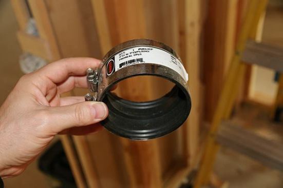 Couplings make the union easy. No need for ALL cast iron, only for vertical drops.