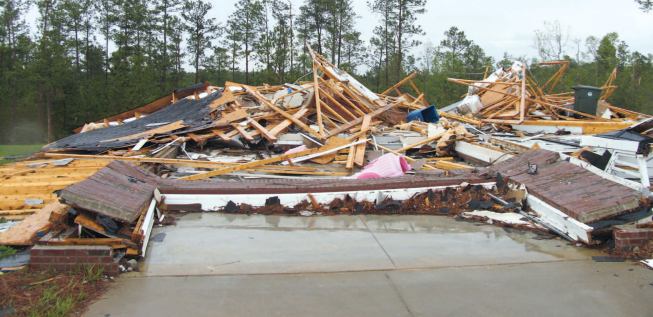 Another home in the same subdivision fared much worse; most likely the garage walls were blown out due to pressurization through the large garage-door opening, seen in the foreground.