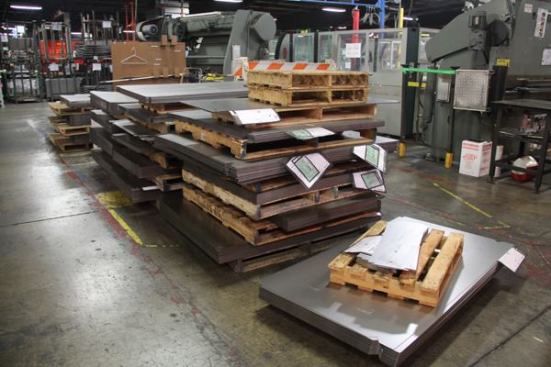 This material has been punched or laser cut to size and stacked close to the machines that will bend it to shape. Similar stacks of material can be found throughout the plant. The tags in the attached bags are work orders that explain what the material is to be made into.