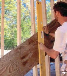 Figure 11. Mark the risers on the stringer by plumbing down.