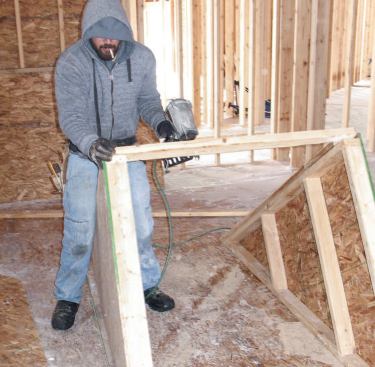 Standing Up the Walls: Next, we stood up the sheathed walls and joined them with a top plate across the front.