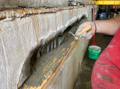 When packing in the mortar the goal is to work it behind the rebar to eliminate any voids.
