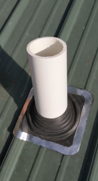 The author then installs a flexible boot (this one is made by Oatey), which has a soft aluminum and lead edge made to conform to the panel ribs (13). (For more on the installation of this type of boot, see the author’s article “Reroofing With Exposed-Fastener Metal Panels,” Sep/20.)