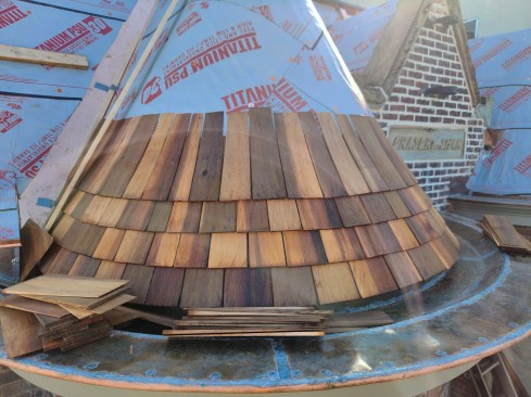 The author special-ordered extra-long, thick shingles that the crew cut at an angle on each side. Before being installed, each shingle was hand-dipped into a tub of a borate-based wood preservative.
