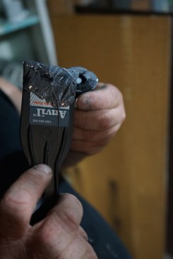 ... and carefully applies this to the perimeter of an injection port. He is careful here to spread the paste only on the flange of each port, so it doesn’t clog the opening.