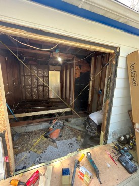 While reframing this area, the author set cross-strings to check the plane of the door opening and corrected for a splay in the wall.