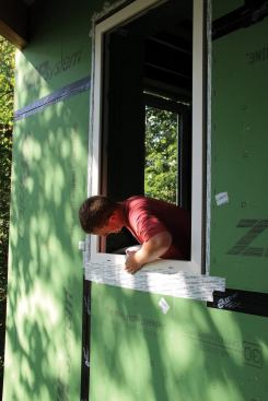 Setting the windows flush to the exterior sheathing makes it simple to integrate them into the weather-resistive barrier and drainage plane by taping the exterior face of the window frame to the Zip sheathing with Siga Wigluv tape.